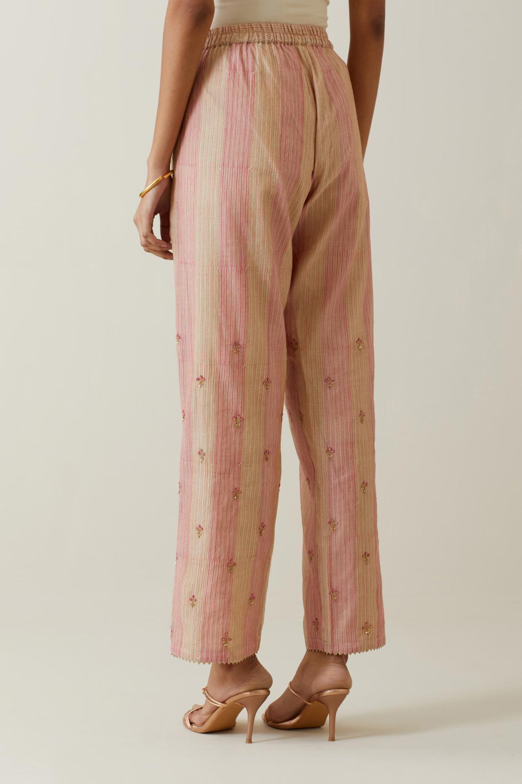 Beige tissue chanderi striped hand block printed straight pants with embroidery at bottom hem.