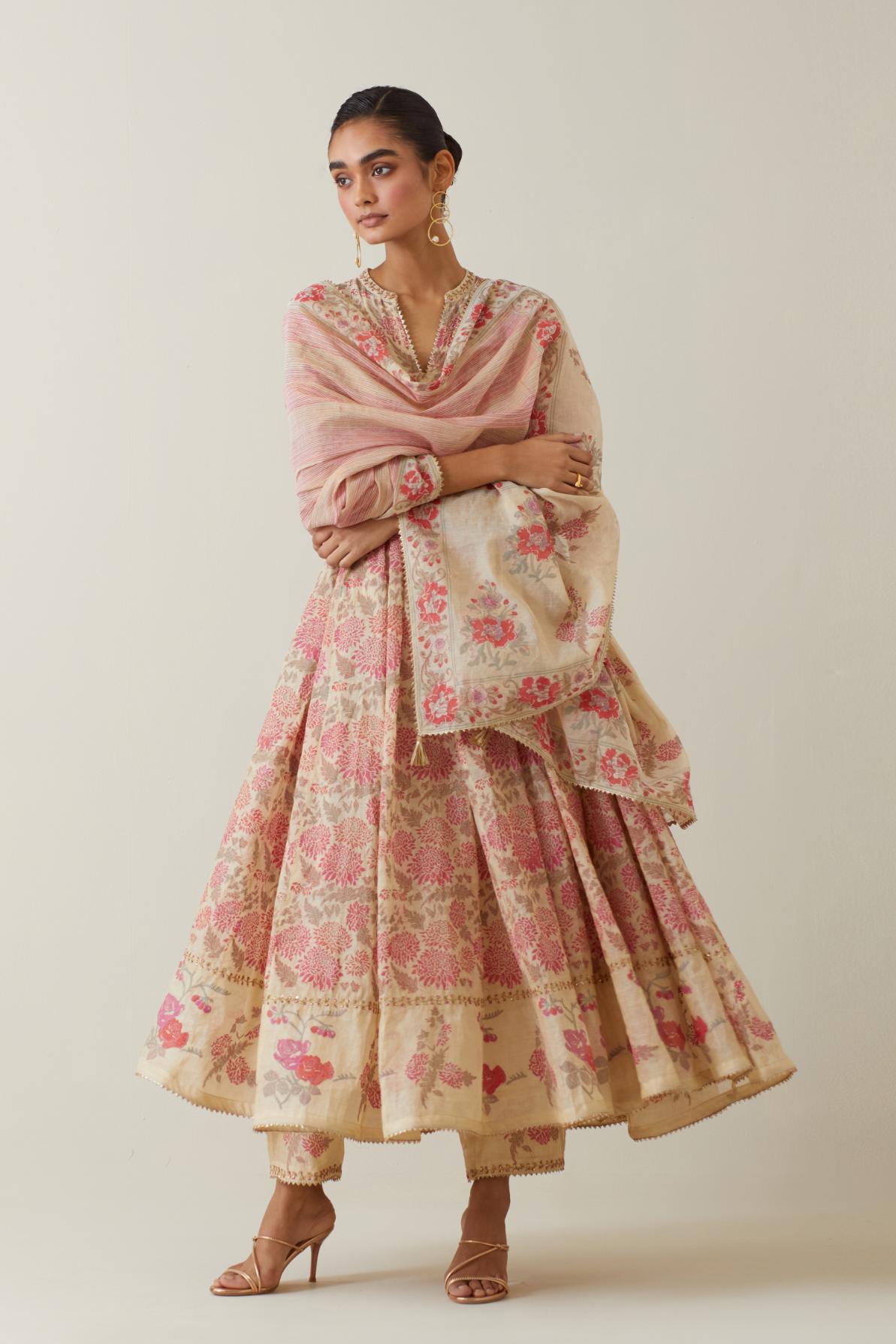 Beige tissue chanderi hand block printed multi-paneled kurta dress set with 3/4 sleeves, highlighted with sequins, thread and zari work.