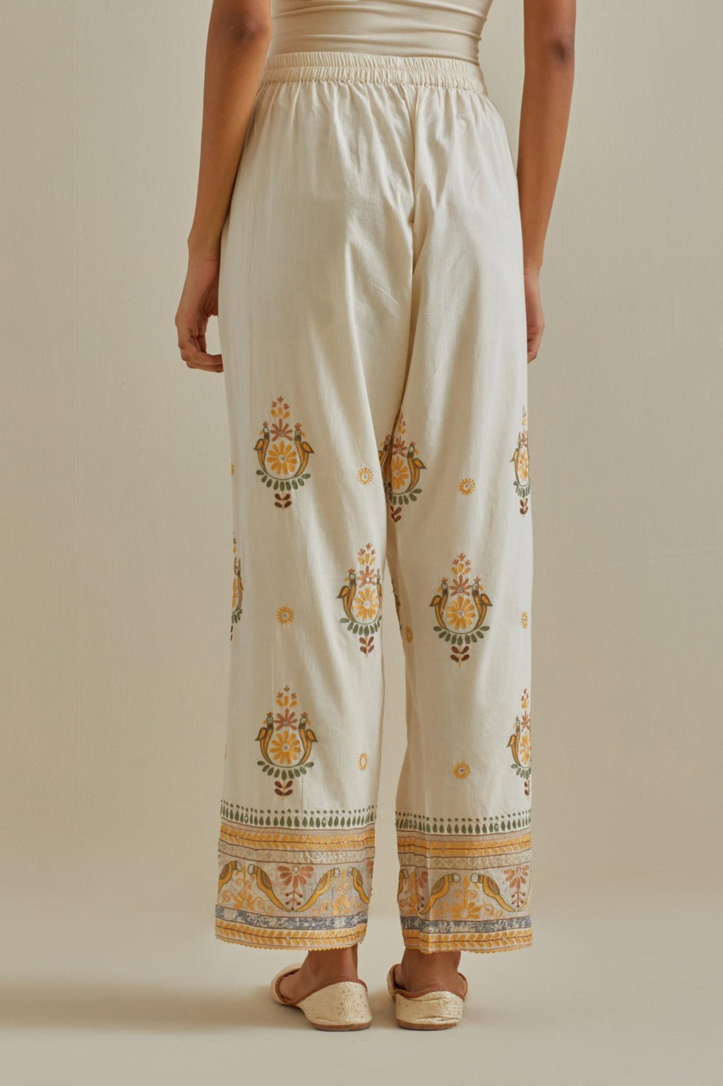 Yellow and off-white straight pants with all over multi color embroidery detailed with sequins.