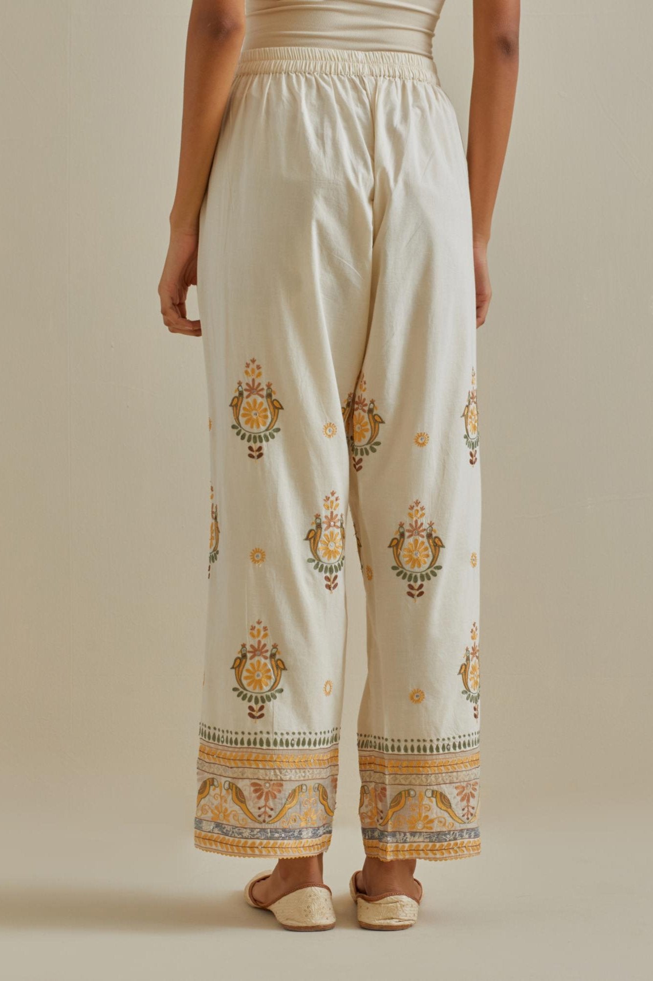 Yellow and off-white straight pants with all over multi color embroidery detailed with sequins.