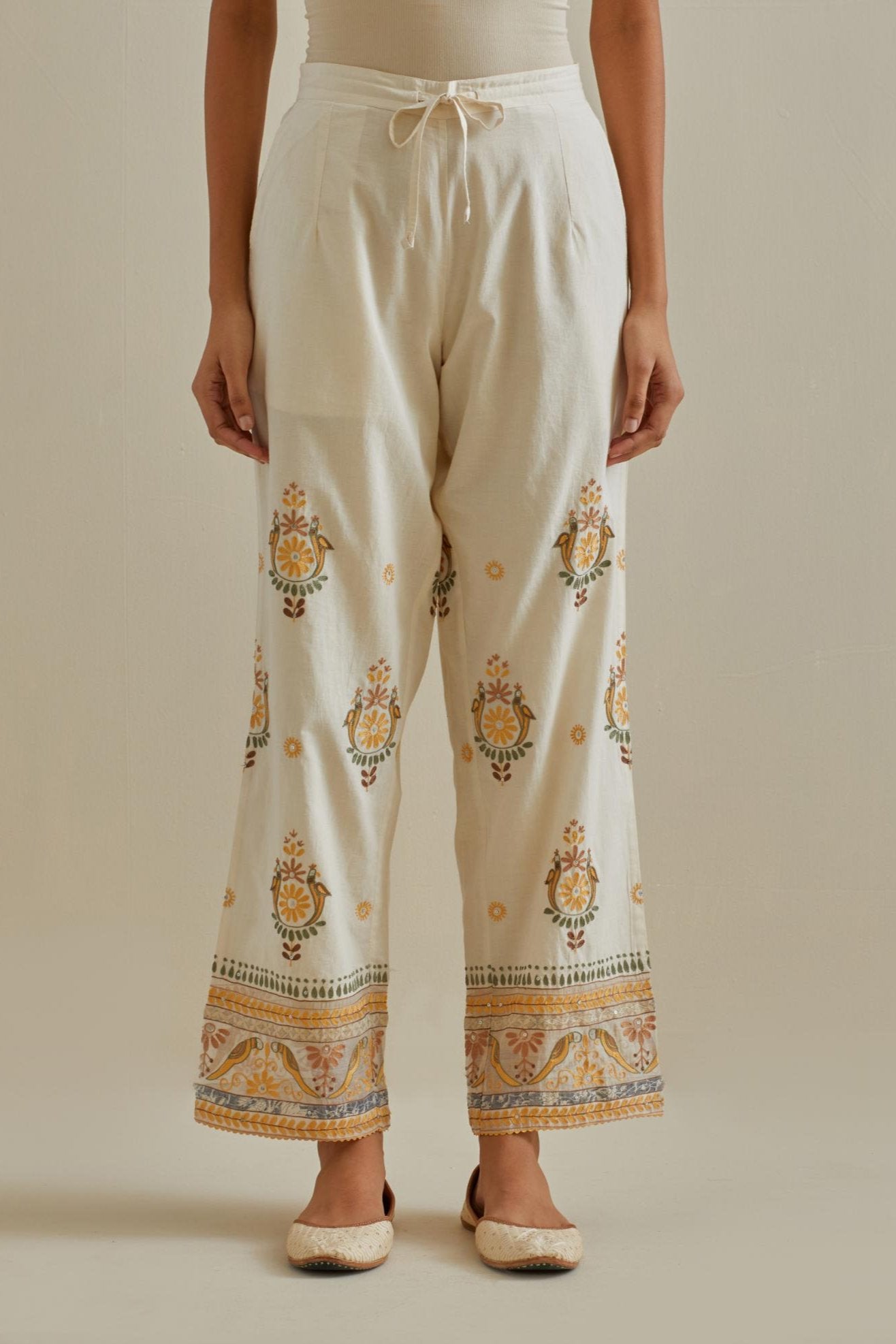 Yellow and off-white straight pants with all over multi color embroidery detailed with sequins.