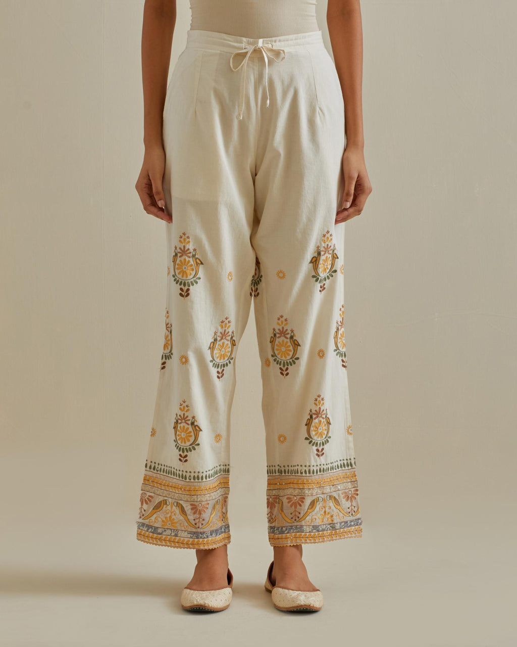 Yellow and off-white straight pants with all over multi color embroidery detailed with sequins.