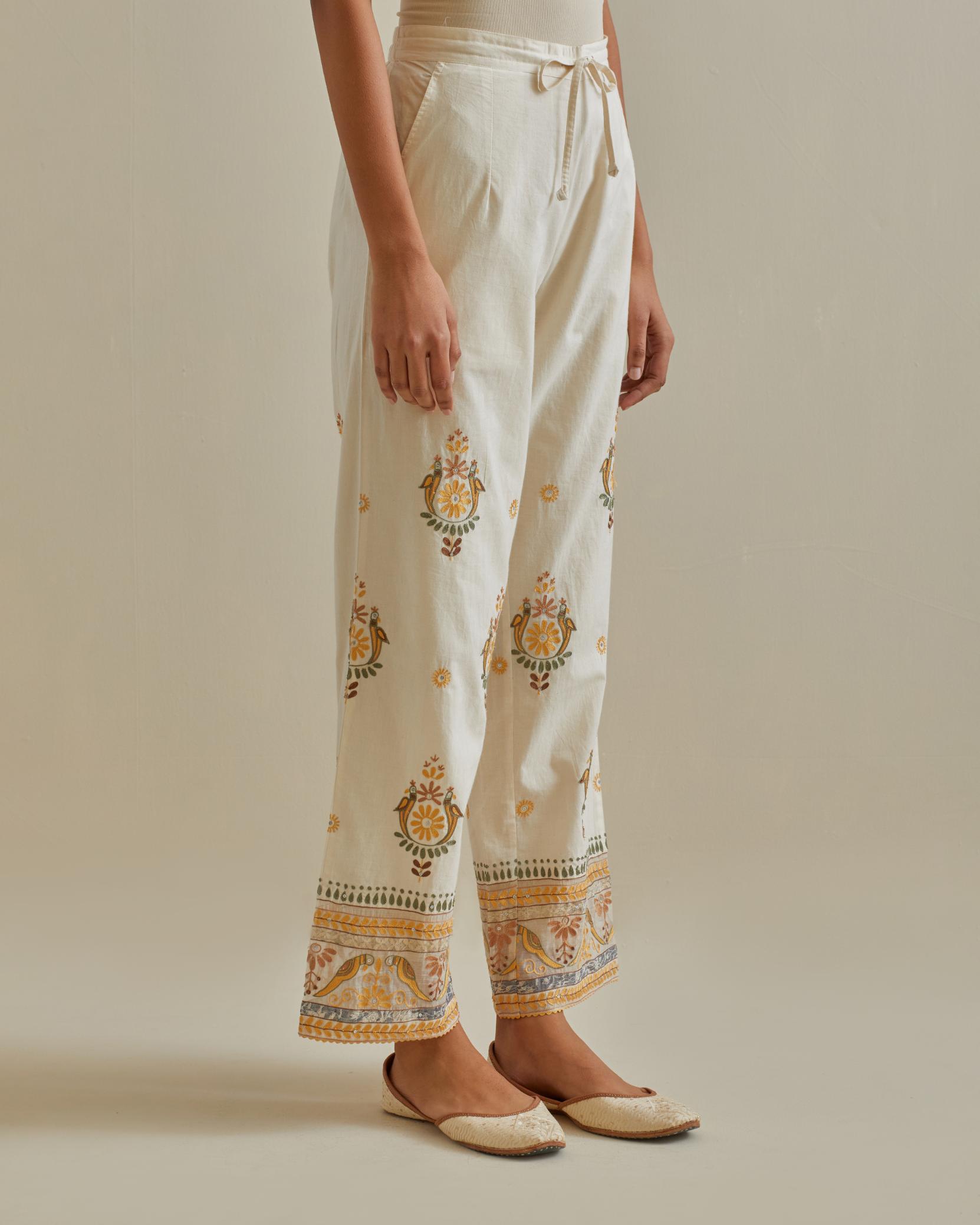 Yellow and off-white straight pants with all over multi color embroidery detailed with sequins.