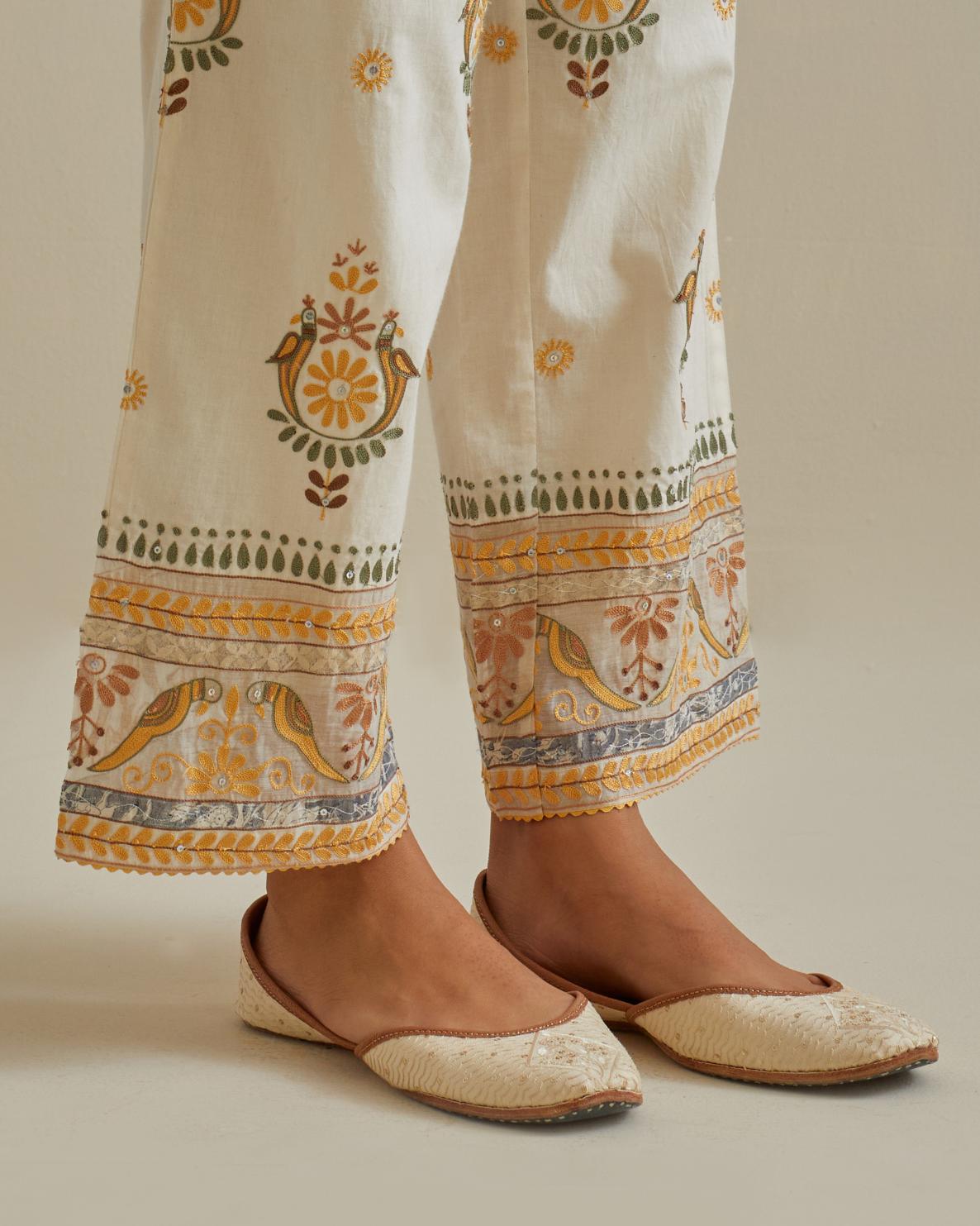 Yellow and off-white straight pants with all over multi color embroidery detailed with sequins.