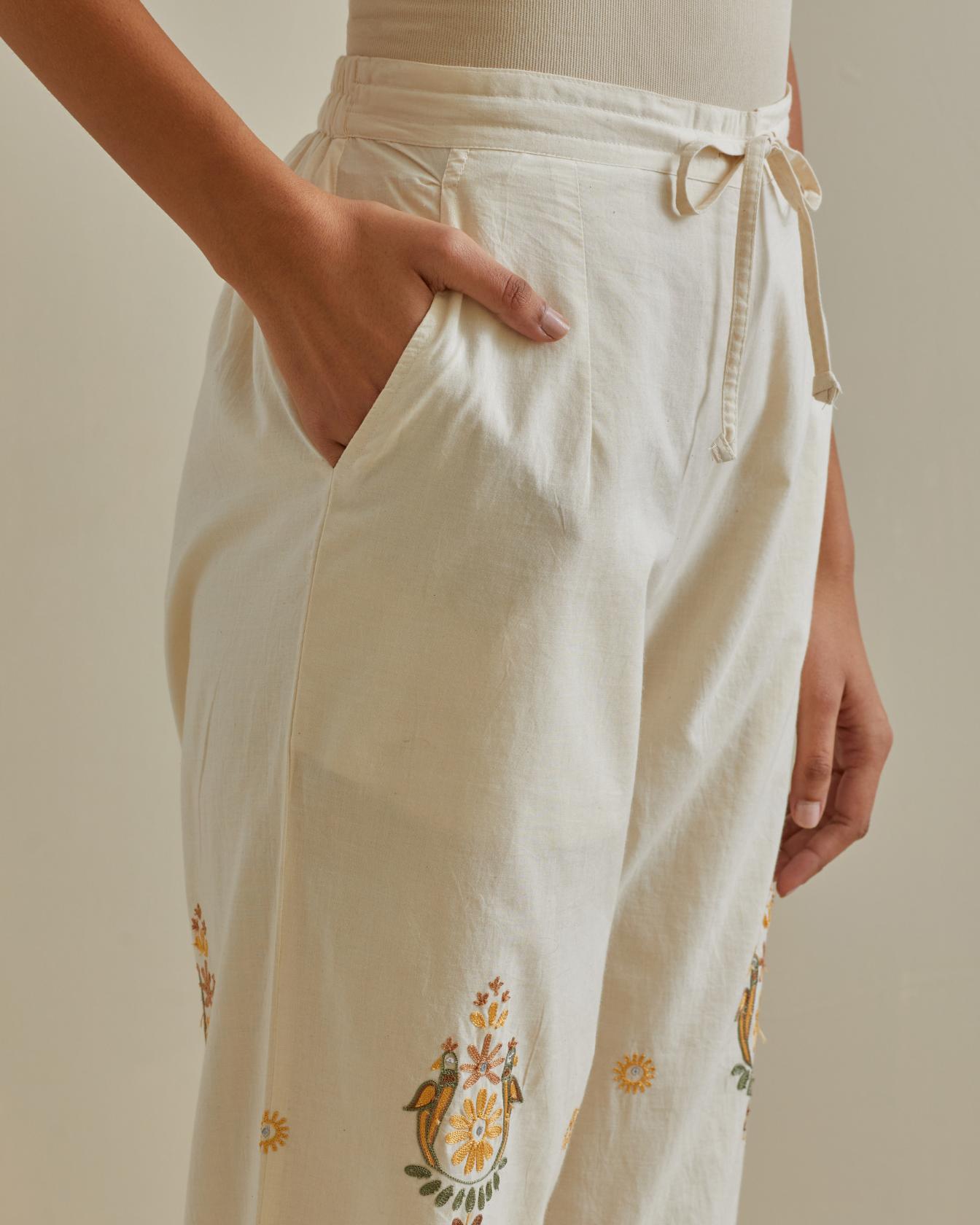 Yellow and off-white straight pants with all over multi color embroidery detailed with sequins.
