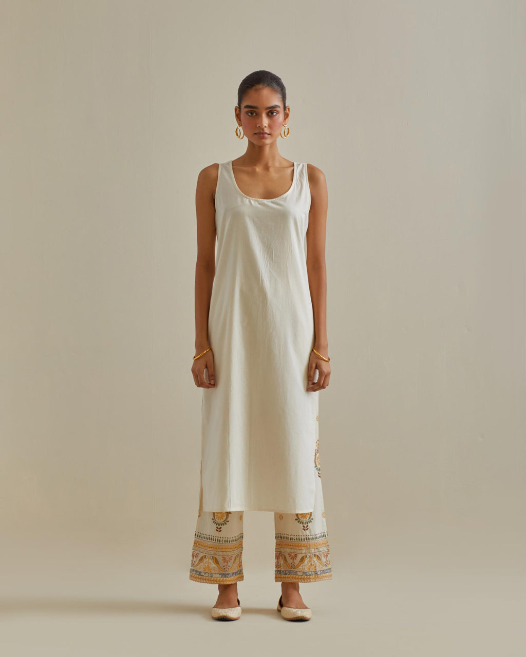 Yellow and off-white cotton chanderi straight kurta set with yoke with patchwork and silk thread embroidery highlighted with mirror, sequins, tassels and braids.