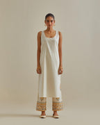 Yellow and off-white cotton chanderi straight kurta set with yoke with patchwork and silk thread embroidery highlighted with mirror, sequins, tassels and braids.