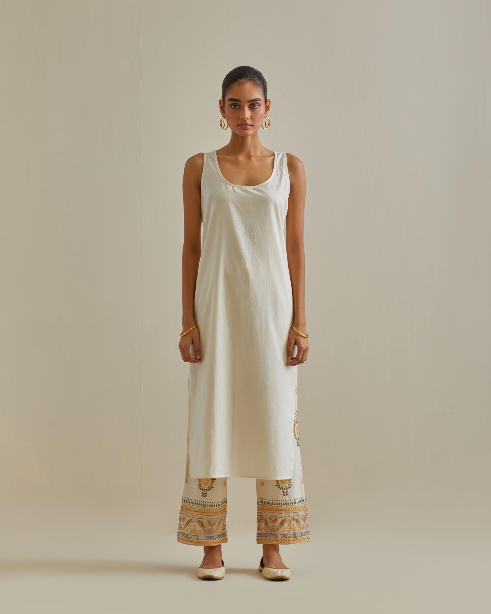 Yellow and off-white cotton chanderi straight kurta set with yoke with patchwork and silk thread embroidery highlighted with mirror, sequins, tassels and braids.