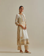 Yellow and off-white cotton chanderi straight kurta set with yoke with patchwork and silk thread embroidery highlighted with mirror, sequins, tassels and braids.