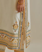 Yellow and off-white cotton chanderi straight kurta set with yoke with patchwork and silk thread embroidery highlighted with mirror, sequins, tassels and braids.