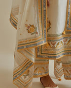 Yellow and off-white cotton chanderi straight kurta set with yoke with patchwork and silk thread embroidery highlighted with mirror, sequins, tassels and braids.