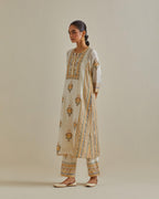 Yellow and off-white cotton chanderi straight kurta set with yoke and side panels. It has allover patchwork and silk thread embroidery, highlighted with mirror, sequins, tassels and braids.