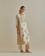 Yellow and off-white cotton chanderi straight kurta set with yoke and side panels. It has allover patchwork and silk thread embroidery, highlighted with mirror, sequins, tassels and braids.