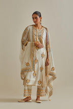 Yellow and off-white cotton chanderi straight kurta set with yoke and side panels. It has allover patchwork and silk thread embroidery, highlighted with mirror, sequins, tassels and braids.