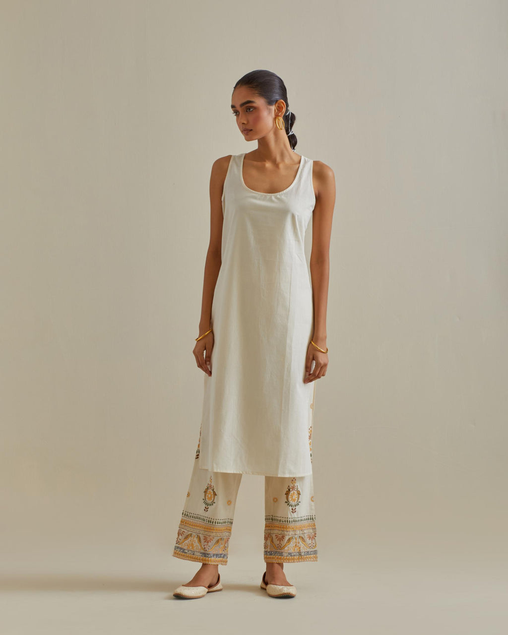 Yellow and off-white cotton chanderi straight kurta set with all over patchwork, silk thread, mirror, tassels and sequins embroidery.
