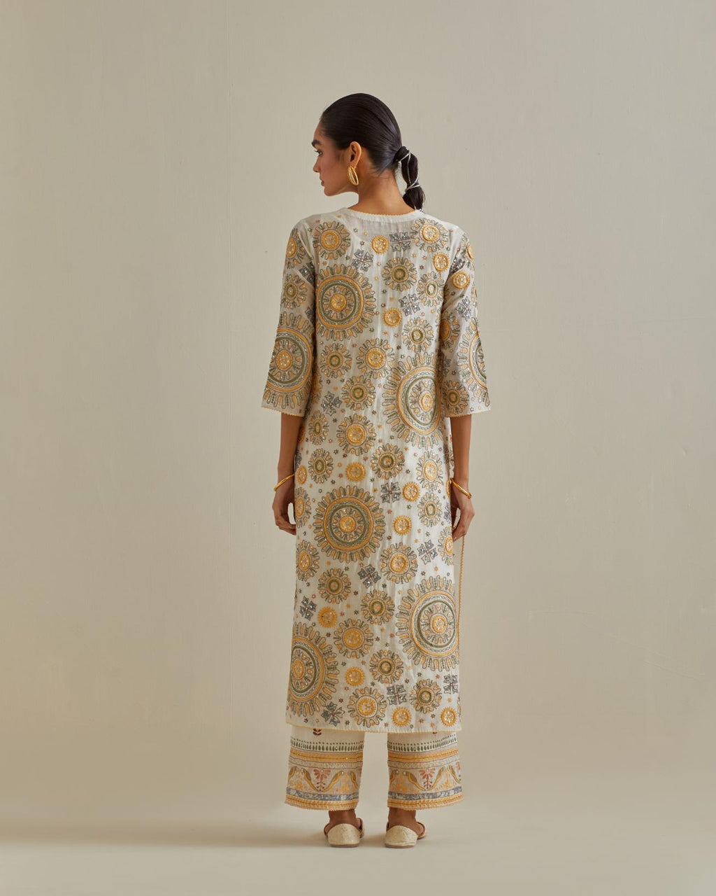 Yellow and off-white cotton chanderi straight kurta set with all over patchwork, silk thread, mirror, tassels and sequins embroidery.