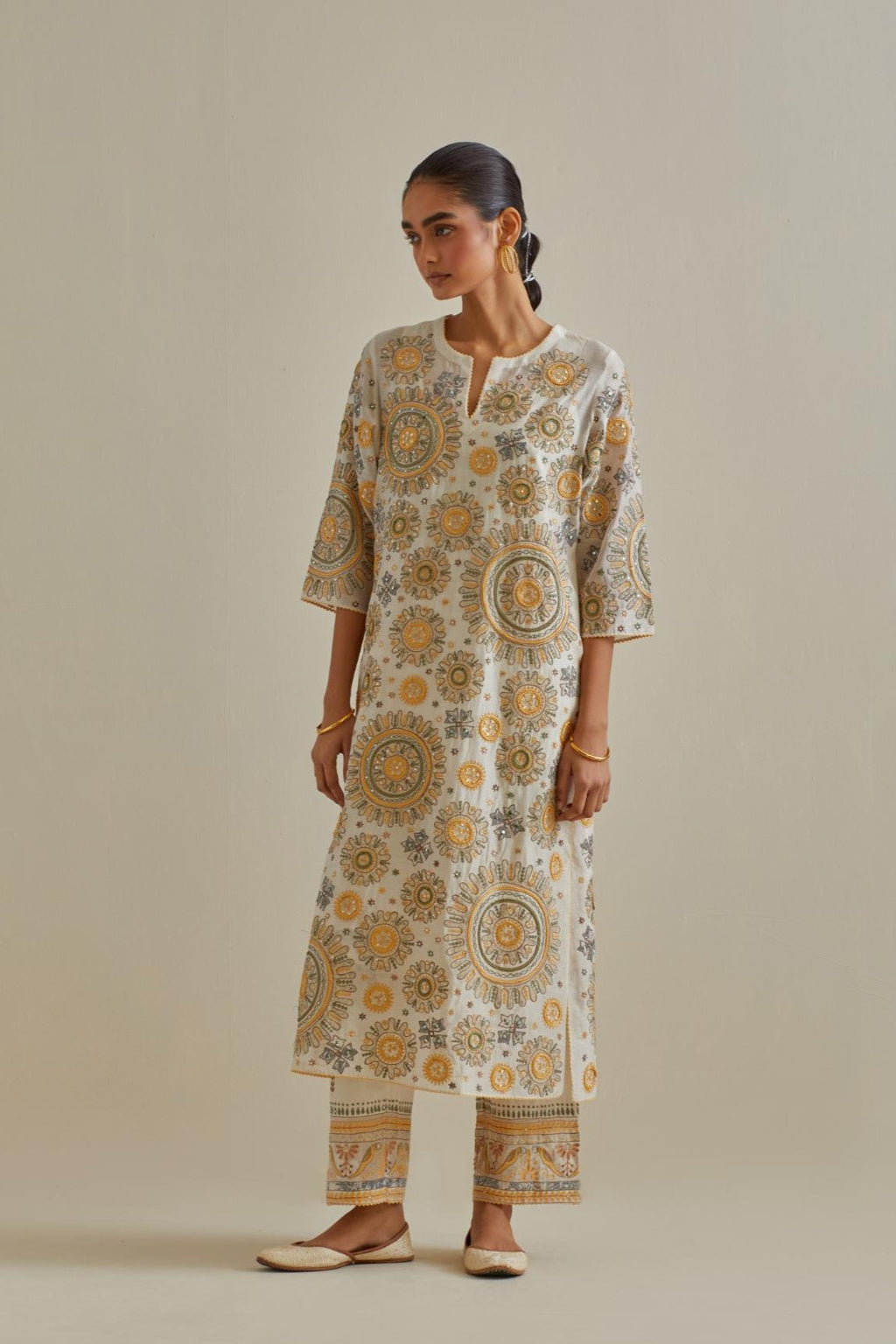 Yellow and off-white cotton chanderi straight kurta set with all over patchwork, silk thread, mirror, tassels and sequins embroidery.