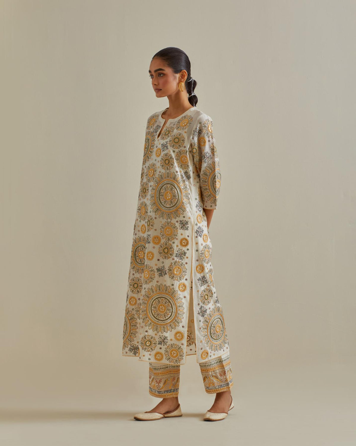 Yellow and off-white cotton chanderi straight kurta set with all over patchwork, silk thread, mirror, tassels and sequins embroidery.