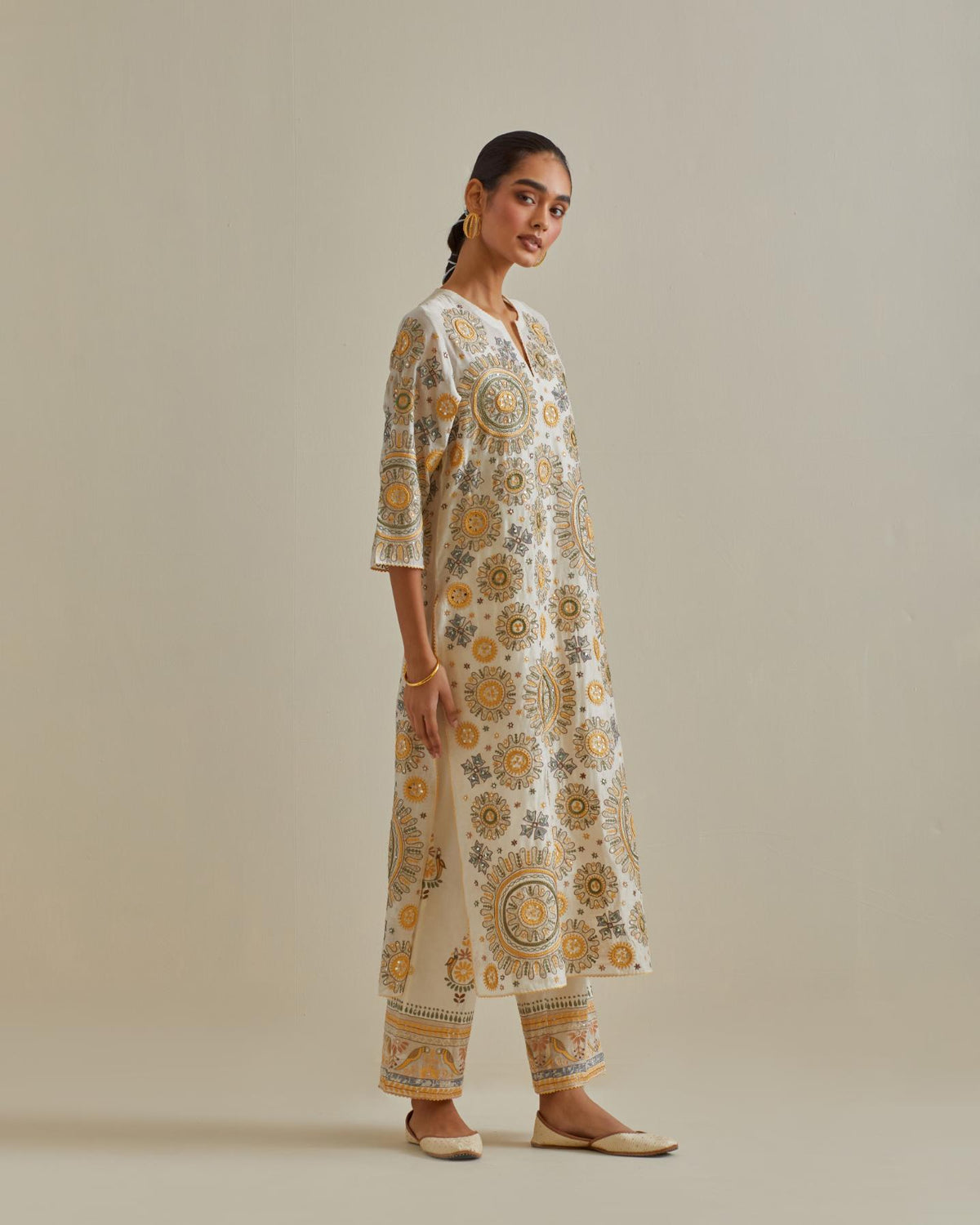 Yellow and off-white cotton chanderi straight kurta set with all over patchwork, silk thread, mirror, tassels and sequins embroidery.
