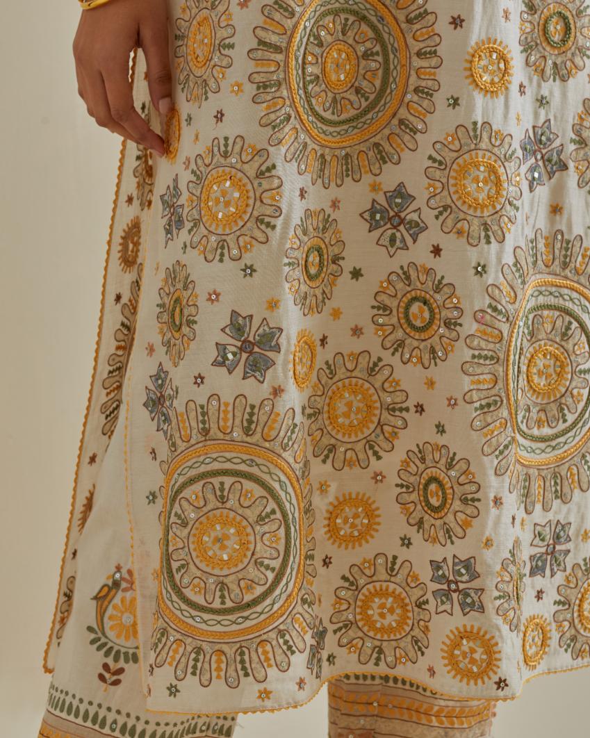 Yellow and off-white cotton chanderi straight kurta set with all over patchwork, silk thread, mirror, tassels and sequins embroidery.