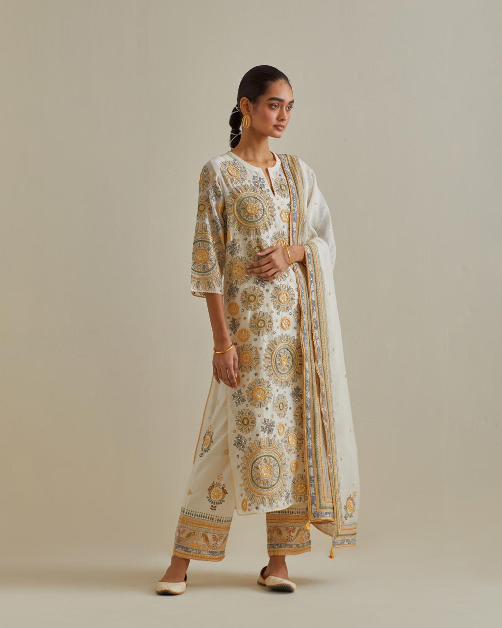 Yellow and off-white cotton chanderi straight kurta set with all over patchwork, silk thread, mirror, tassels and sequins embroidery.