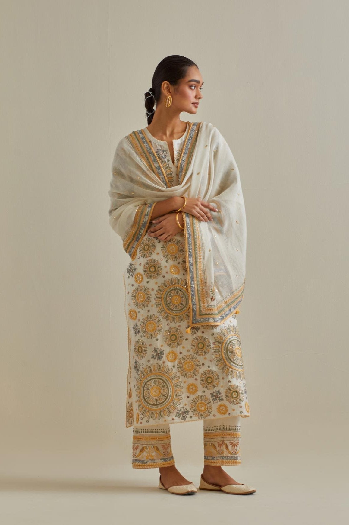Yellow and off-white cotton chanderi straight kurta set with all over patchwork, silk thread, mirror, tassels and sequins embroidery.