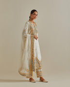 Yellow and off-white cotton chanderi straight kurta set with patchwork and thread embroidery highlighted with mirrors, sequins, tassels and braids.