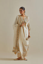 Yellow and off-white cotton chanderi straight kurta set with patchwork and thread embroidery highlighted with mirrors, sequins, tassels and braids.