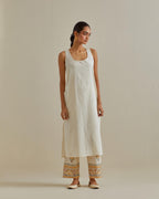 Yellow and off-white cotton chanderi straight kurta set with yoke with patchwork and silk thread embroidery highlighted with mirror, sequins, tassels and braids.