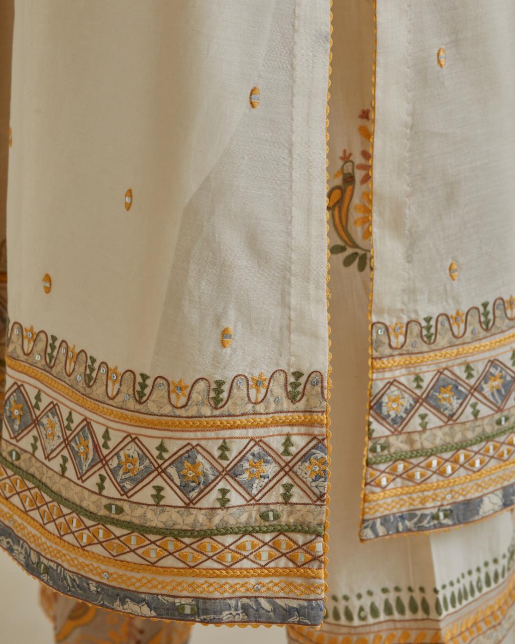 Yellow and off-white cotton chanderi straight kurta set with yoke with patchwork and silk thread embroidery highlighted with mirror, sequins, tassels and braids.
