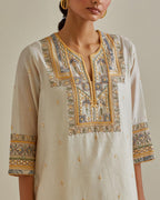 Yellow and off-white cotton chanderi straight kurta set with yoke with patchwork and silk thread embroidery highlighted with mirror, sequins, tassels and braids.