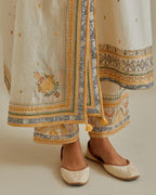 Yellow and off-white cotton chanderi straight kurta set with yoke with patchwork and silk thread embroidery highlighted with mirror, sequins, tassels and braids.