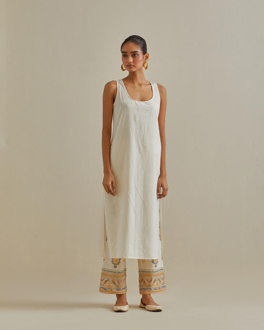 Yellow and off-white cotton chanderi straight kurta set with all over chevron pattern. It is embellished with silk patchwork, thread, sequins and mirrors.
