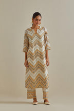 Yellow and off-white cotton chanderi straight kurta set with all over chevron pattern. It is embellished with silk patchwork, thread, sequins and mirrors.