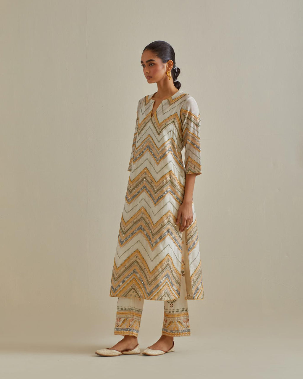 Yellow and off-white cotton chanderi straight kurta set with all over chevron pattern. It is embellished with silk patchwork, thread, sequins and mirrors.