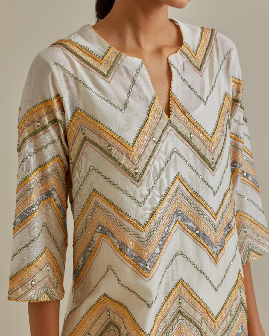 Yellow and off-white cotton chanderi straight kurta set with all over chevron pattern. It is embellished with silk patchwork, thread, sequins and mirrors.