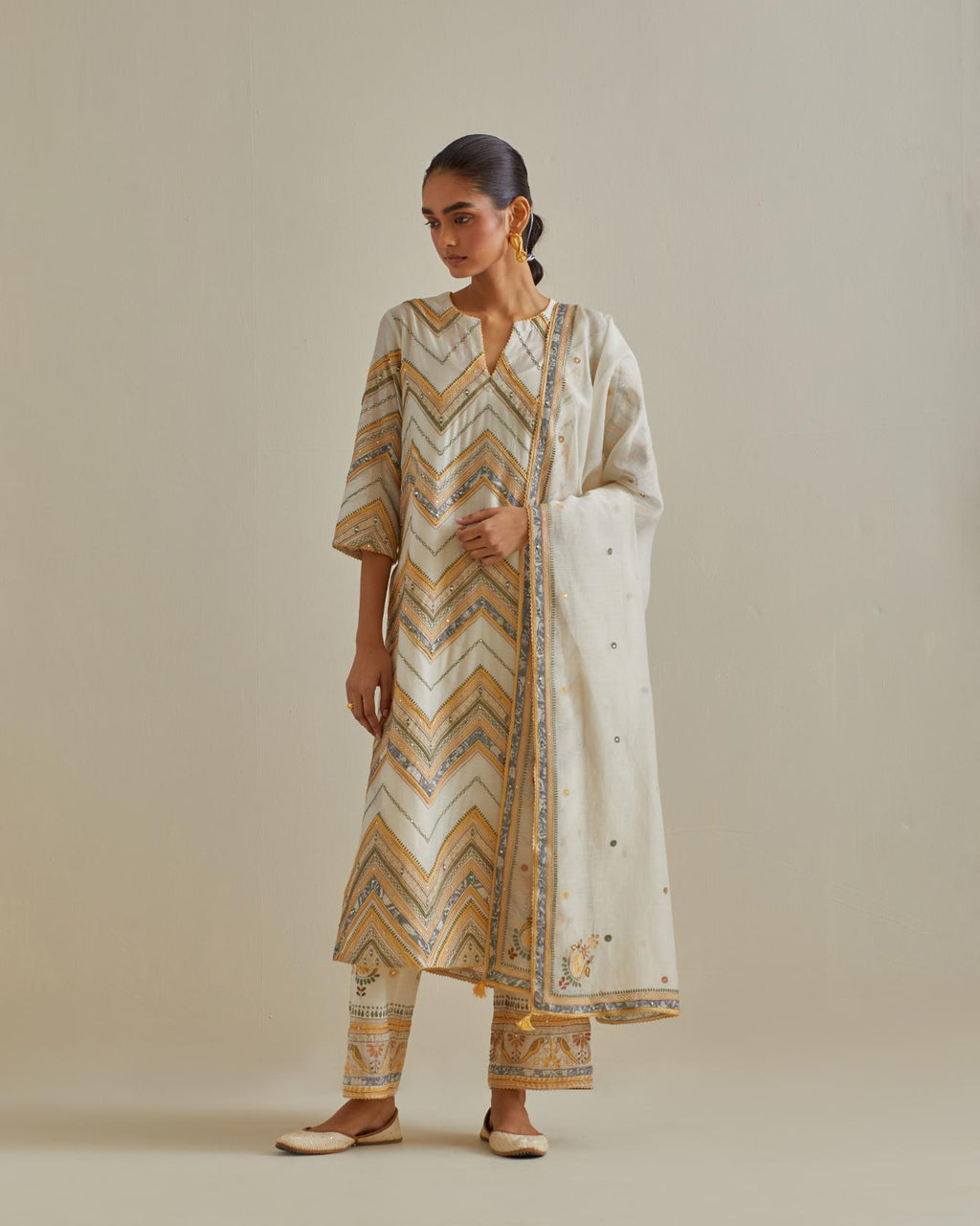 Yellow and off-white cotton chanderi dupatta with delicate silk thread embroidery, highlighted with braids, mirrors and sequins work.