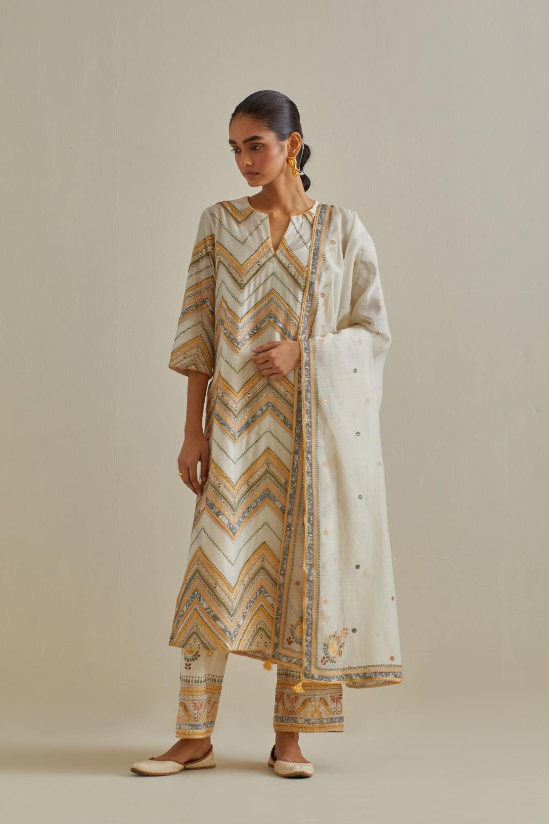 Yellow and off-white cotton chanderi straight kurta set with all over chevron pattern. It is embellished with silk patchwork, thread, sequins and mirrors.