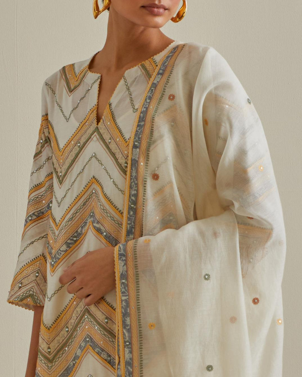 Yellow and off-white cotton chanderi straight kurta set with all over chevron pattern. It is embellished with silk patchwork, thread, sequins and mirrors.