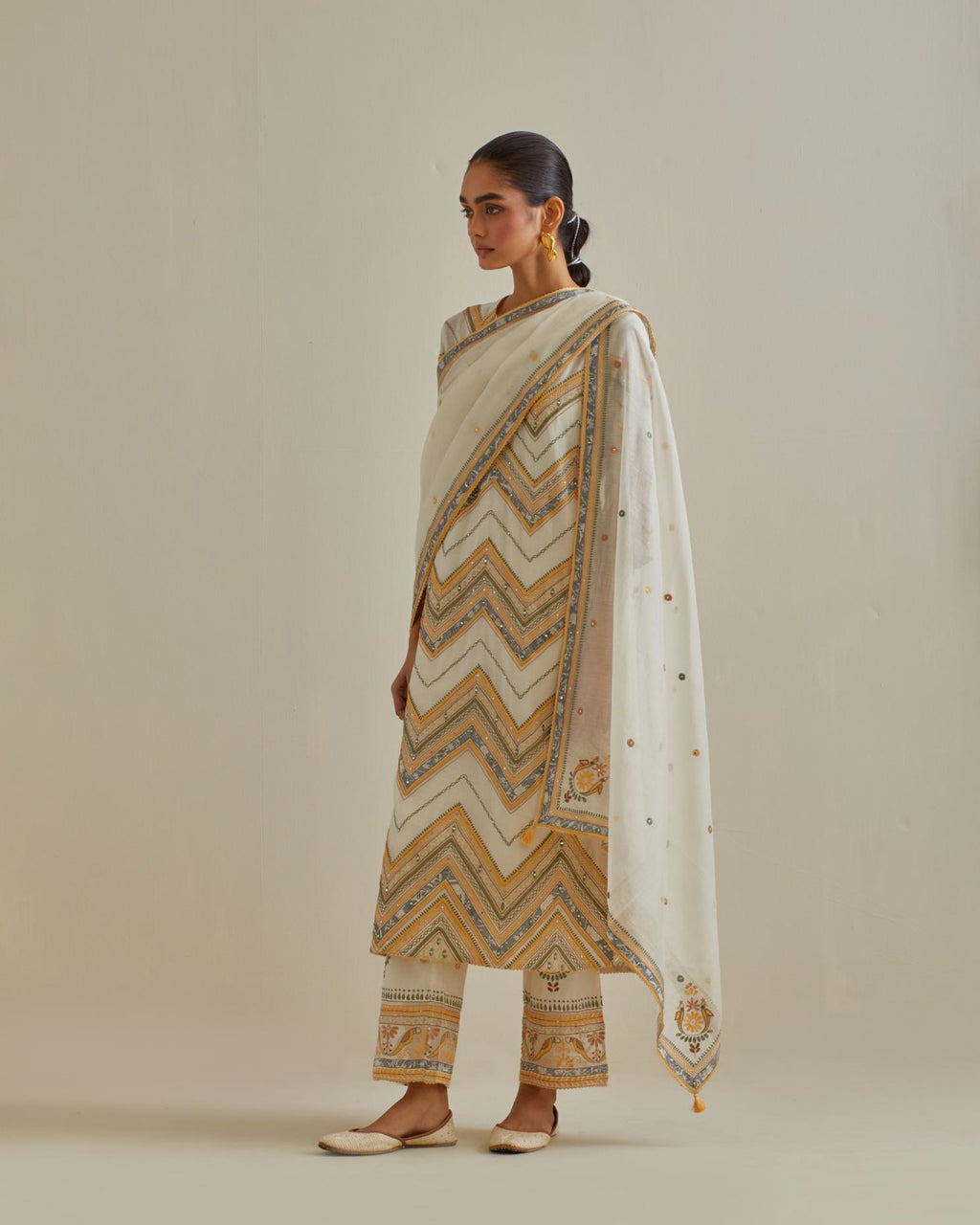 Yellow and off-white cotton chanderi straight kurta set with all over chevron pattern. It is embellished with silk patchwork, thread, sequins and mirrors.