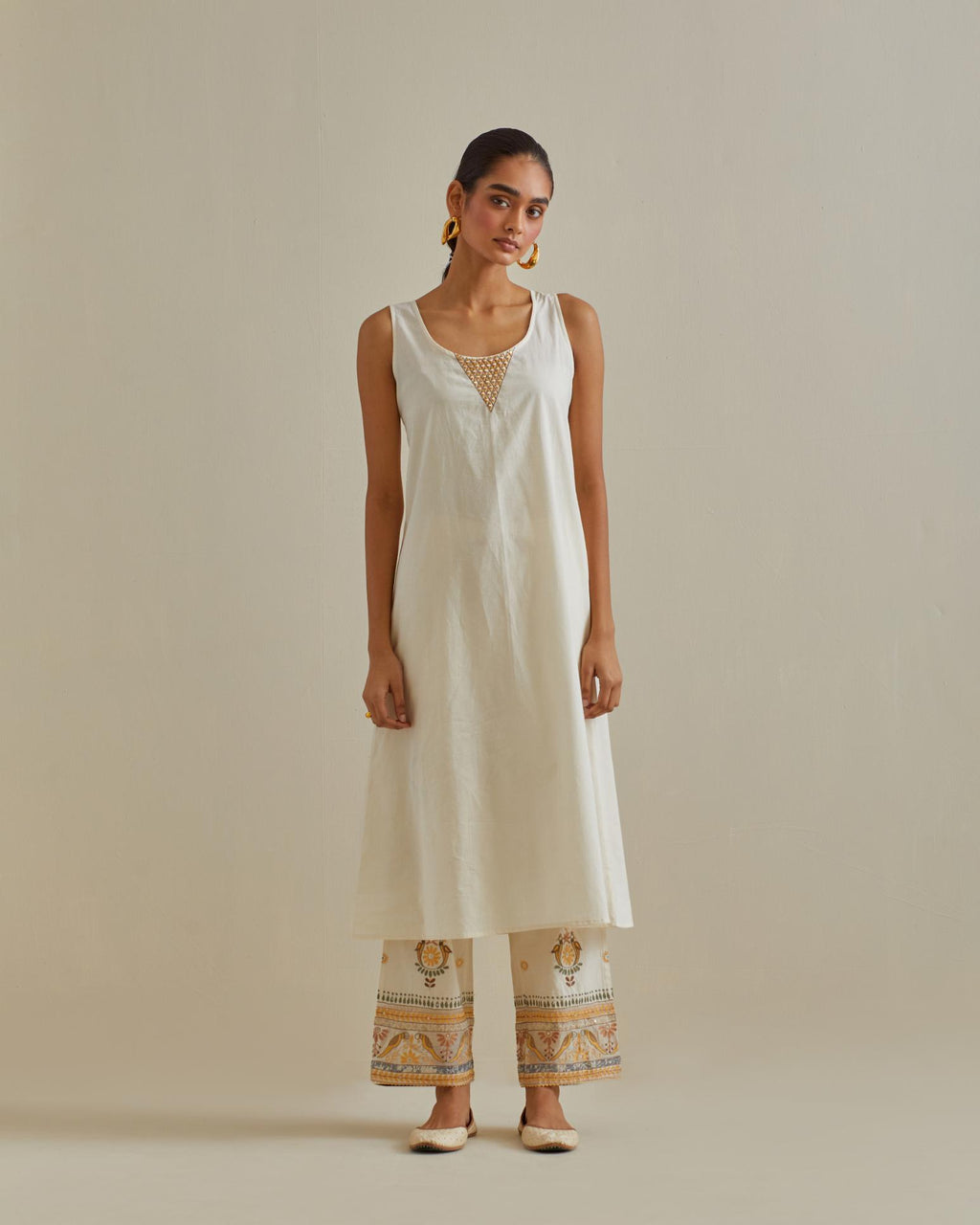 Yellow and off-white cotton chanderi embroidered kurta dress set with V neck, yoke and fine gathers at empire line.