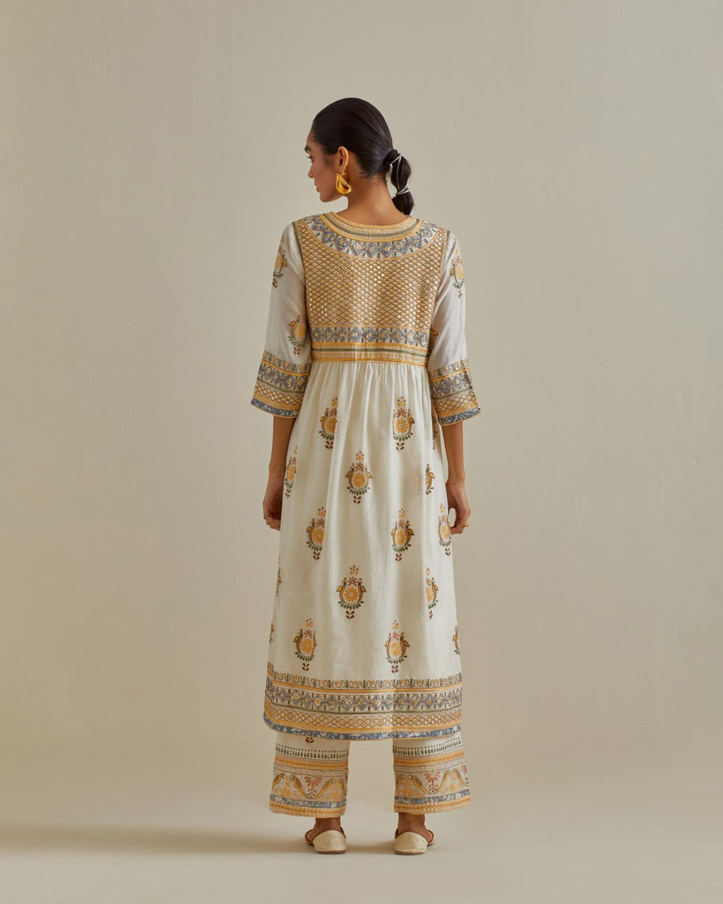 Yellow and off-white cotton chanderi embroidered kurta dress set with V neck, yoke and fine gathers at empire line.