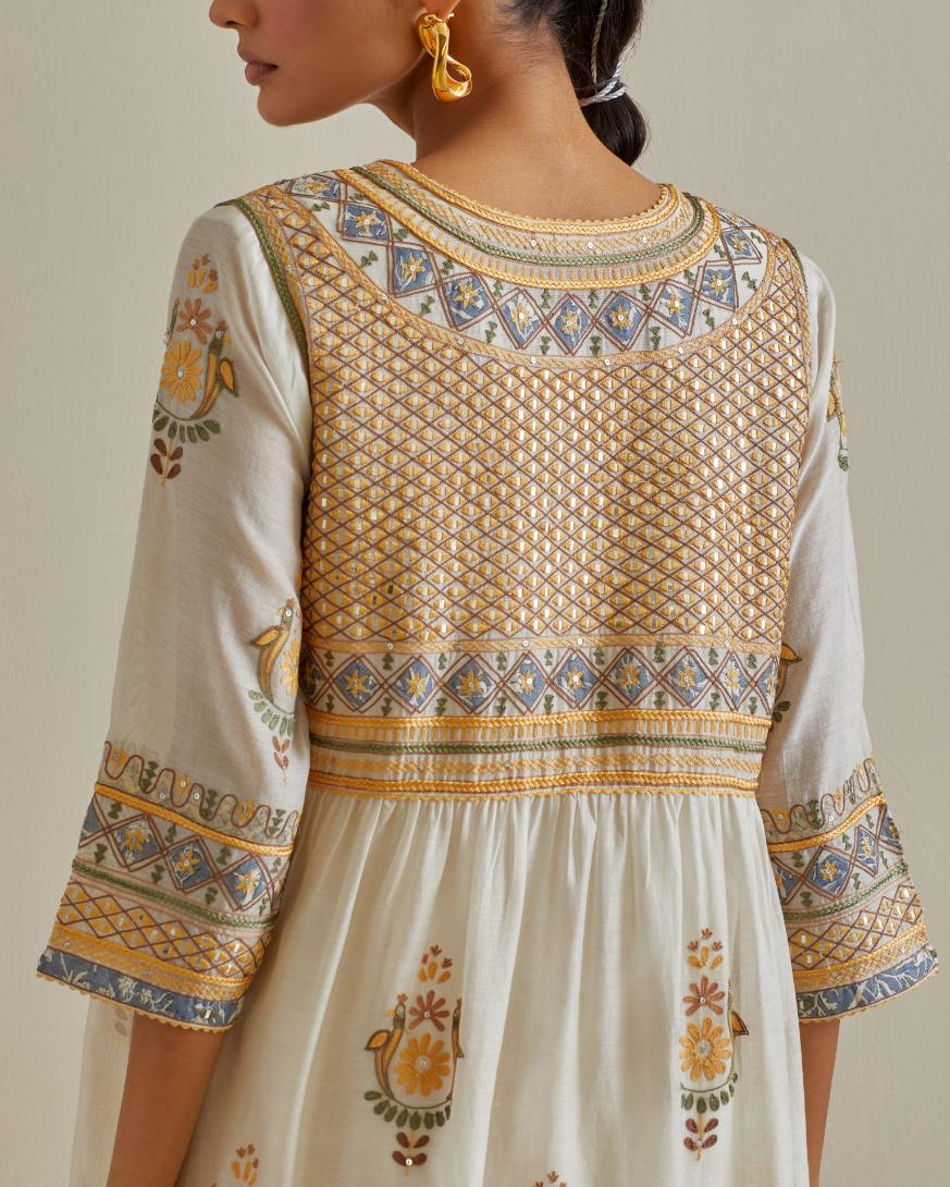 Yellow and off-white cotton chanderi embroidered kurta dress set with V neck, yoke and fine gathers at empire line.