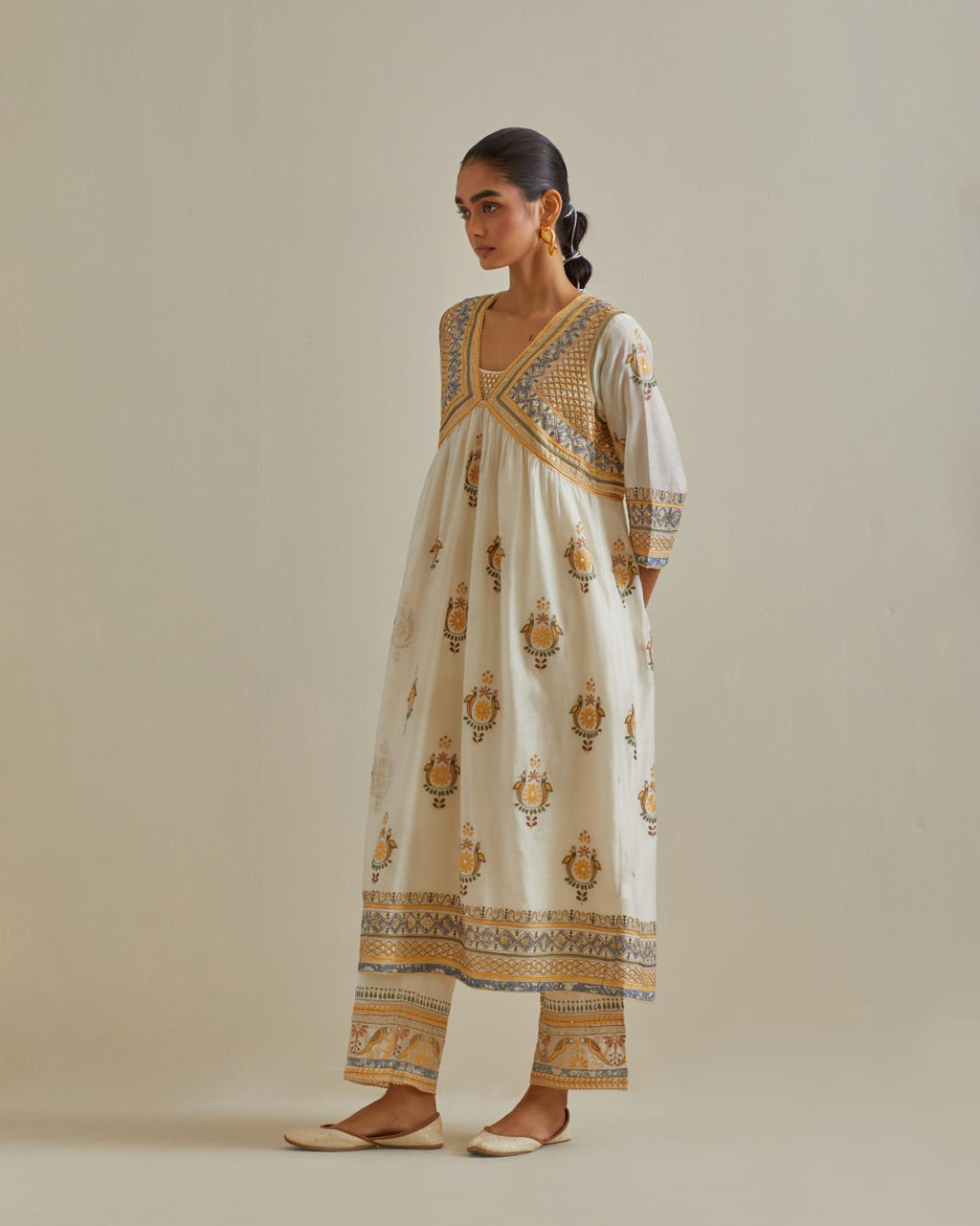 Yellow and off-white cotton chanderi embroidered kurta dress set with V neck, yoke and fine gathers at empire line.
