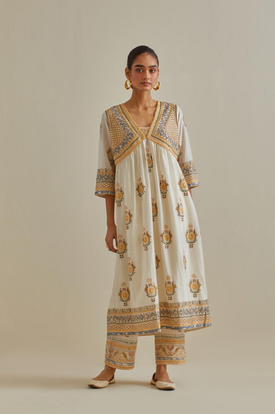 Yellow and off-white cotton chanderi embroidered kurta dress set with V neck, yoke and fine gathers at empire line.