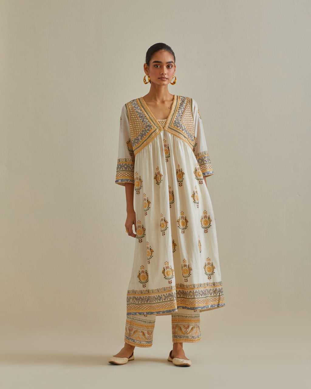 Yellow and off-white cotton chanderi embroidered kurta dress set with V neck, yoke and fine gathers at empire line.
