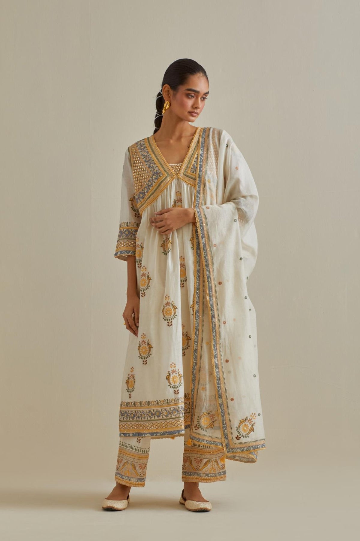 Yellow and off-white cotton chanderi embroidered kurta dress set with V neck, yoke and fine gathers at empire line.
