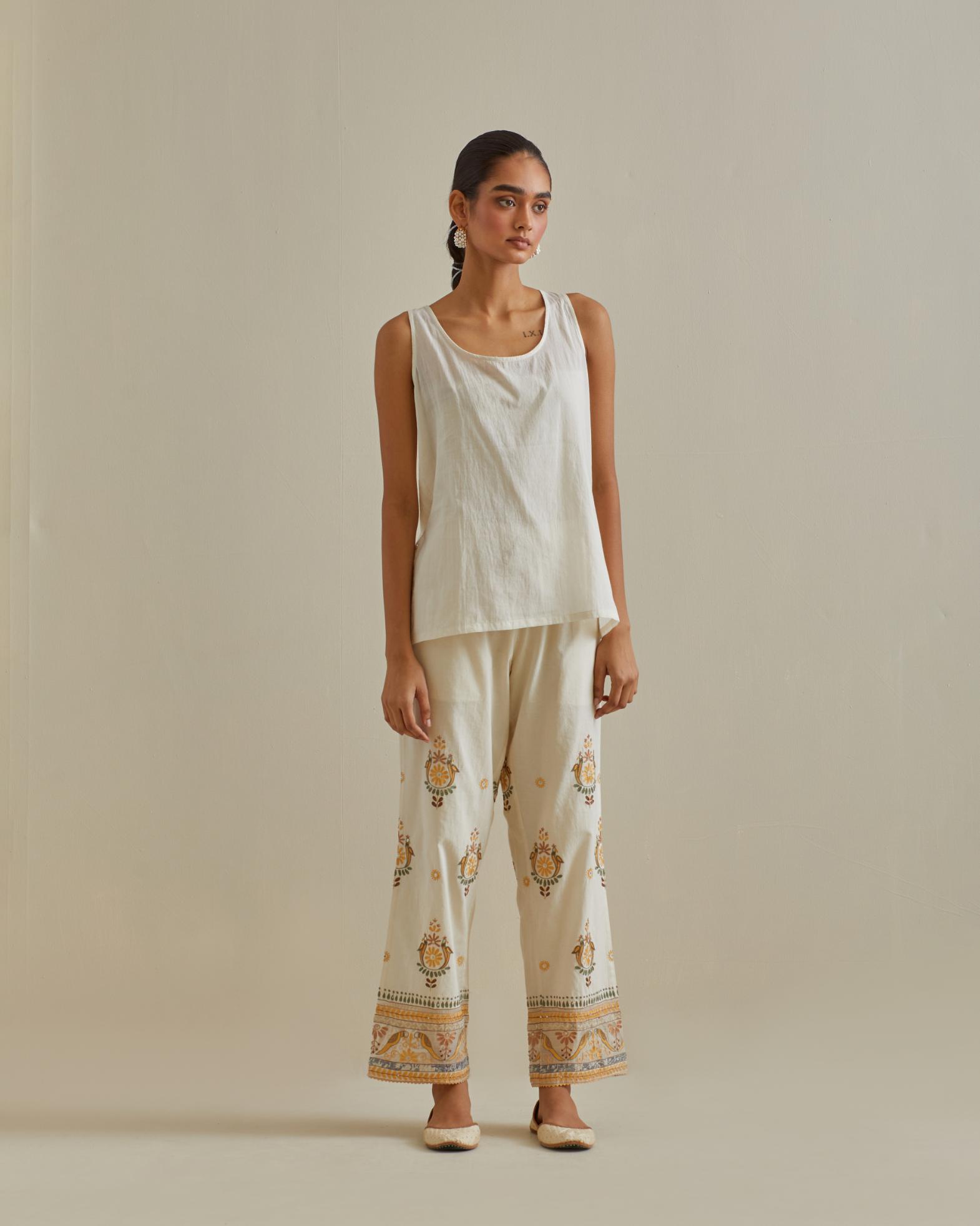 Yellow and off-white cotton chanderi embroidered shirt with full sleeves, paired with off white cotton straight pants with all over multi color embroidery detailed with sequins.