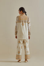 Yellow and off-white cotton chanderi embroidered shirt with full sleeves, paired with off white cotton straight pants with all over multi color embroidery detailed with sequins.