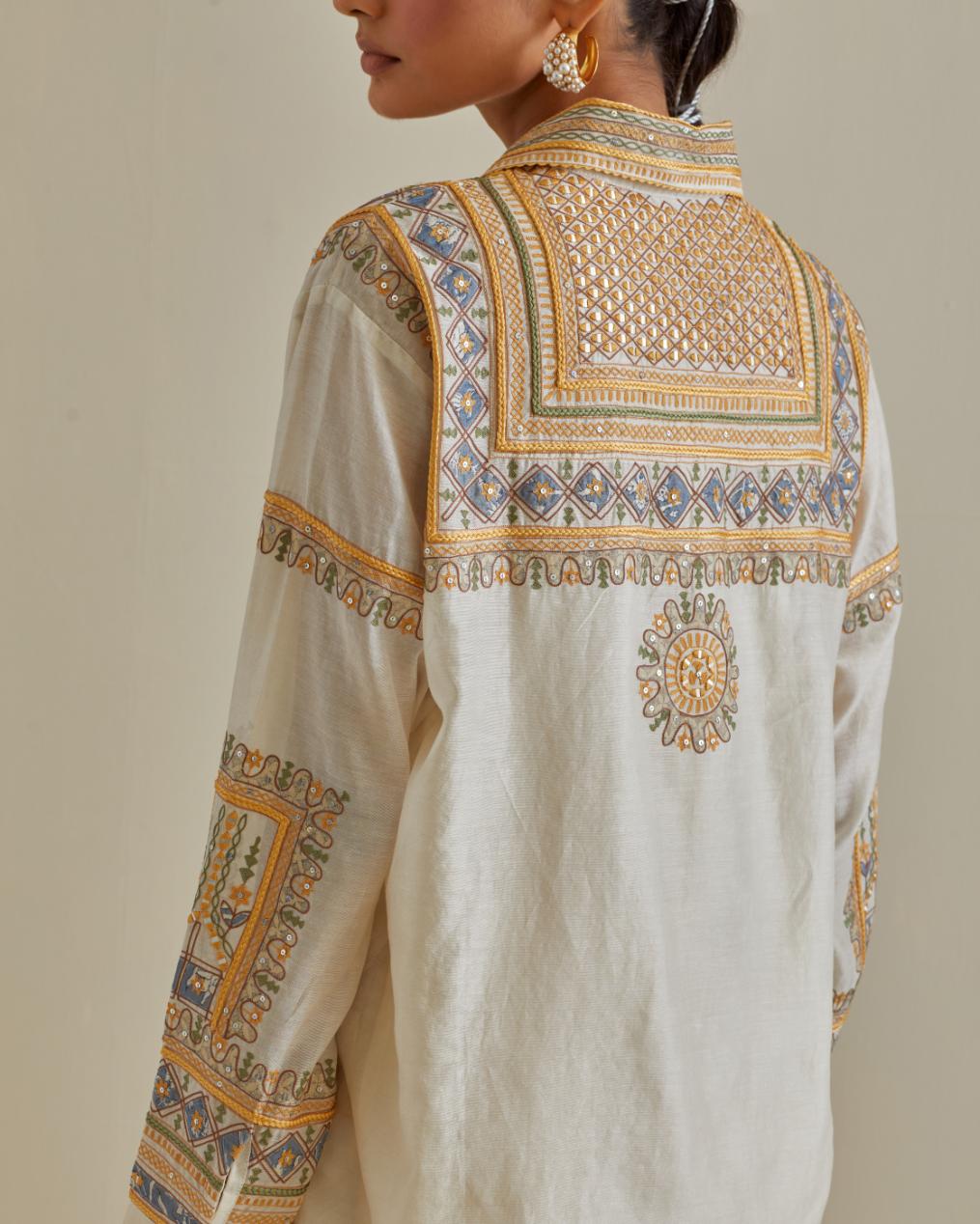 Yellow and off-white cotton chanderi embroidered shirt with full sleeves, paired with off white cotton straight pants with all over multi color embroidery detailed with sequins.